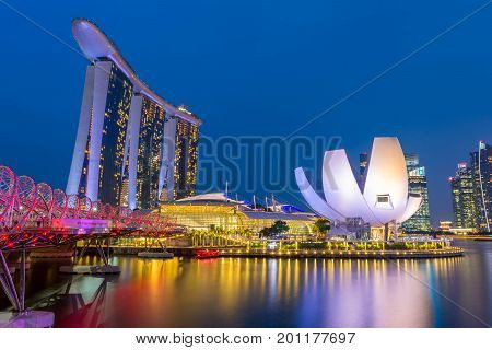 Singapore, Singapore - August 24, 2017: View at the Marina Bay in Singapore during the night with the iconic landmarks of The Helix Bridge.