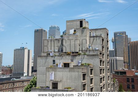 SYDNEY,NSW,AUSTRALIA-NOVEMBER 20,2016: The Sirius Building brutalist architecture with urban skyline and a blue sky in Sydney, Australia