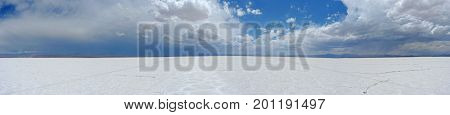 Neverending white The blue and cloudy sky covering a white salty desert. The picture was taken in Salinas Grandes Argentina