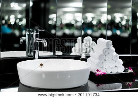 Interior of bathroom with washbasin faucet and white towel in hotel. Modern design of bathroom.