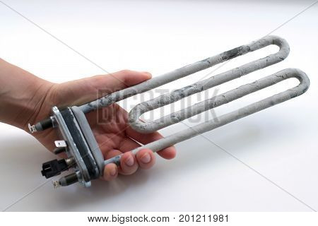Hand holding washing machine heater on a white background