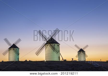 Illuminaed traditional windmills at rising Campo de Criptana Spain