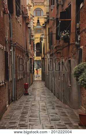 Narrow canals and alleyways in Venice. City of monuments in gondola.