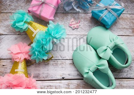 Little girlie baby shoes on a wood