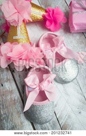 Little girlie baby shoes on a wood