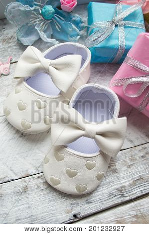 Little girlie baby shoes on a wood