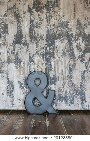 a big metal letter over a textured wall in a vintage Location