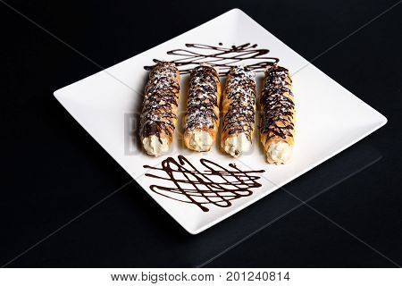 Homemade traditional Sicilian sweet cannoli stuffed ricotta cheese cream, selective focus and blank space