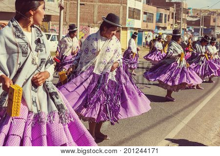PUNO, PERU - AUGUST 07: Authentic Colorful Carnival on the streets of Puno, Peru near the high altutude Titicaca lake on August 7th, 2017
