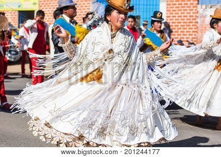 PUNO, PERU - AUGUST 07: Authentic Colorful Carnival on the streets of Puno, Peru near the high altutude Titicaca lake on August 7th, 2017