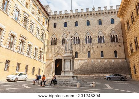 Siena, Italy - April 04, 2017: A small square with a monument to Sallustio Bandini