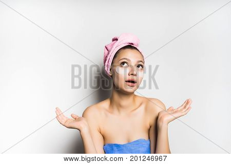 Woman with mask under eye on white