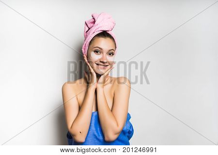 Woman with mask under eye on white