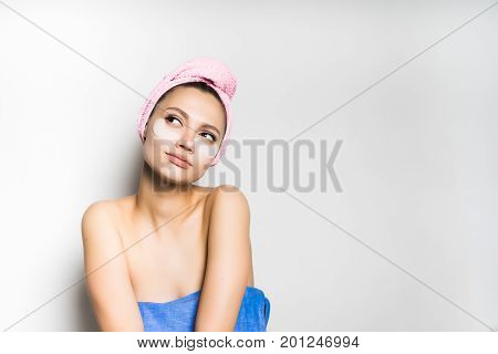 Woman with mask under eye on white