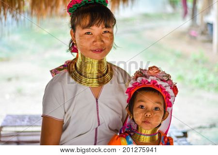 CHIANG MAI, THAILAND - July 10, 2017: Karen hill-tribe (Long Neck) woman weaving fabrics for a living at her house.