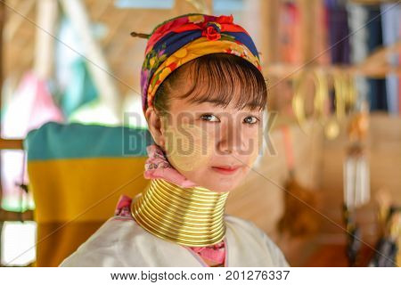 CHIANG MAI, THAILAND - July 10, 2017: Karen hill-tribe (Long Neck) woman weaving fabrics for a living at her house.