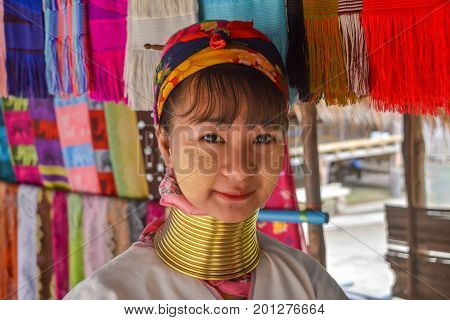CHIANG MAI, THAILAND - July 10, 2017: Karen hill-tribe (Long Neck) woman weaving fabrics for a living at her house.