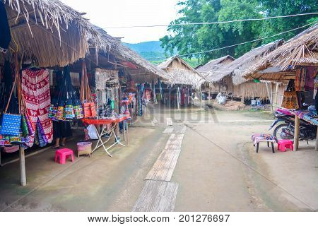 CHIANG MAI, THAILAND - July 10, 2017: Karen hill-tribe (Long Neck) woman weaving fabrics for a living at her house.