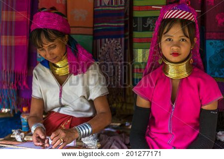 CHIANG MAI, THAILAND - July 10, 2017: Karen hill-tribe (Long Neck) woman weaving fabrics for a living at her house.