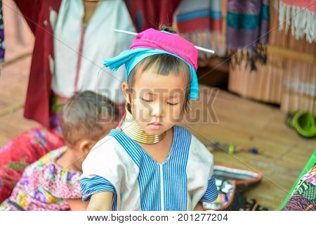 CHIANG MAI, THAILAND - July 10, 2017: Karen hill-tribe (Long Neck) woman weaving fabrics for a living at her house.