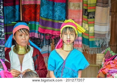 CHIANG MAI, THAILAND - July 10, 2017: Karen hill-tribe (Long Neck) woman weaving fabrics for a living at her house.