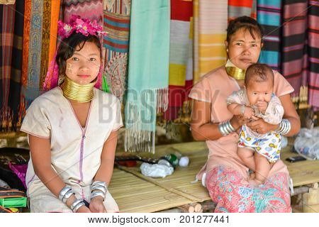 CHIANG MAI, THAILAND - July 10, 2017: Karen hill-tribe (Long Neck) woman weaving fabrics for a living at her house.