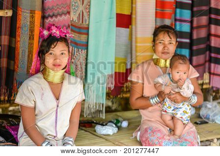 CHIANG MAI, THAILAND - July 10, 2017: Karen hill-tribe (Long Neck) woman weaving fabrics for a living at her house.
