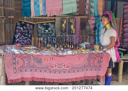 CHIANG MAI, THAILAND - July 10, 2017: Karen hill-tribe (Long Neck) woman weaving fabrics for a living at her house.