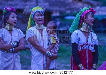 CHIANG MAI, THAILAND - July 10, 2017: Karen hill-tribe (Long Neck) woman weaving fabrics for a living at her house.