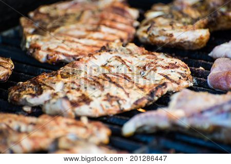 Delicious pork steaks with seasoning on the grill