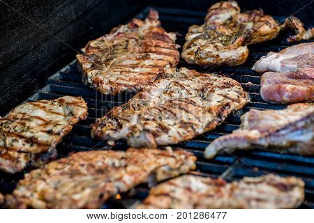 Delicious pork steaks with seasoning on the grill