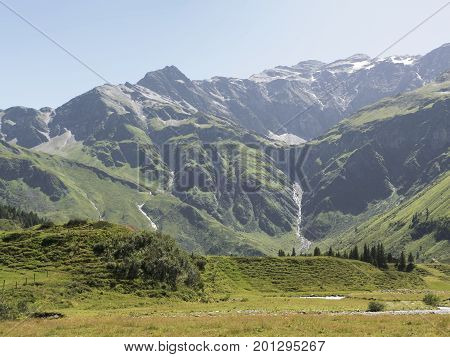 Alpine massif, beautiful Alpine canyon in Austria. Alpine Gastein Valley in summer. Mountains and pastures. Fresh air and healthy virgin nature. Excursional destination for hiking, vacation.