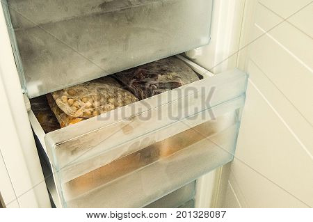 Hide food in deep freeze, get food from deep freeze, view through open door deep freeze
