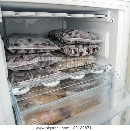 Freezing food in deep freeze, deep-freezing frozen fruit, deep freeze and food