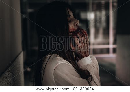 Zombie woman death the ghost drain hand blood skin is screaming darkness and nightmare background horror of scary fear on hell is monster devil girl in halloween festival concept