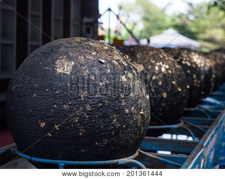 Cicle stone with thin golden paper call is Looknimit Thai traditional religion ceremony to set up boundary of temple or Wat.
