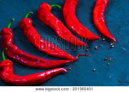 Red hot chili peppers on slate background
