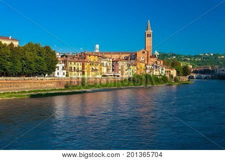 VERONA ITALY- September 08 2016: Morning scenery with Adige River Bell tower of Santa Anastasia's church and the embankment of Adige River.