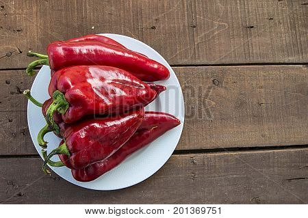 The most beautiful concept is Red fresh chilli on wood desk.
Red Hot Chili Peppers over wooden background