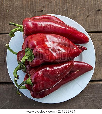 The most beautiful concept is Red fresh chilli on wood desk.
Red Hot Chili Peppers over wooden background