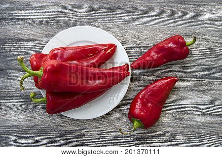 The most beautiful concept is Red fresh chilli on wood desk.
Red Hot Chili Peppers over wooden background