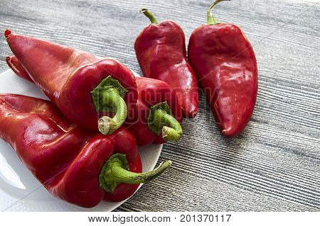 The most beautiful concept is Red fresh chilli on wood desk.
Red Hot Chili Peppers over wooden background