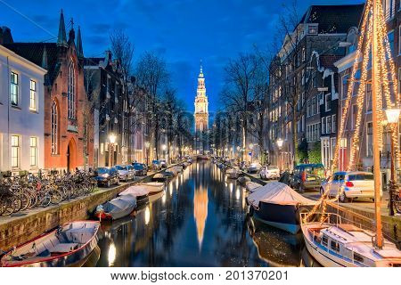 The canal in Amsterdam with Zuiderkerk church in Amsterdam city Netherlands.