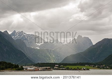 Andalsnes and mountains along the Romsdalsfjorden under a cloudy sky Norway
