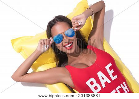 Sexy tanned brunette in sunglasses smiling and enjoying her summer weekend sunny shot