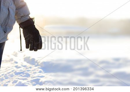 hand in warm gloves on background of snow. copy space