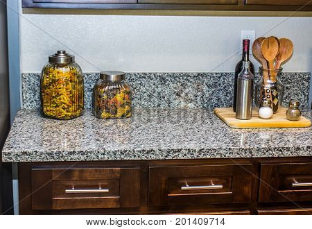 Modern Kitchen Granite Counter With Pasta Containers & Utensils