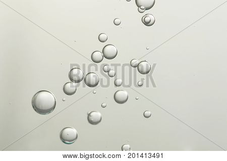 Flowing air bubbles over a blurred background