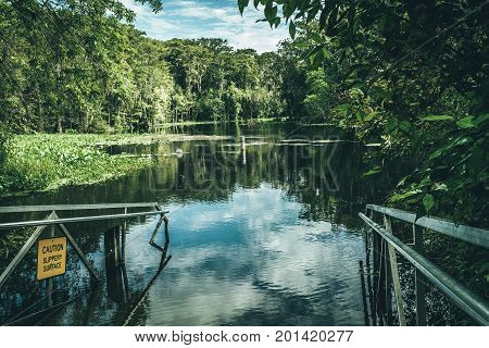 kayak and boat ramp into natural spring water seen while hiking on a hot summer morning in florida