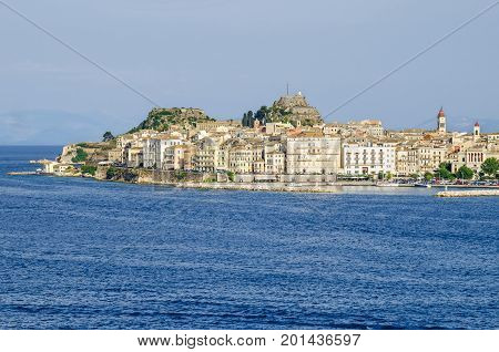 Old Corfu town with the Venetian Old Fortress and the bell tower of the Saint Spyridon Church as seen from the harbor. Greece.